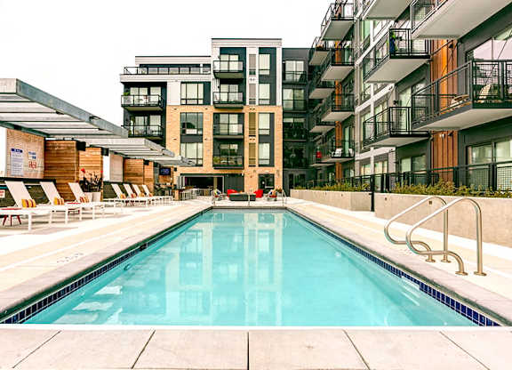 a swimming pool in front of an apartment building