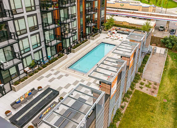 A modern building with a pool and a glass wall.