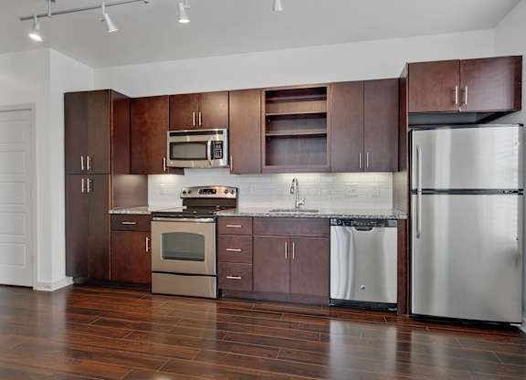 12 South Apartments - Nashville TN - kitchen with dark wood cabinets and stainless steel appliances