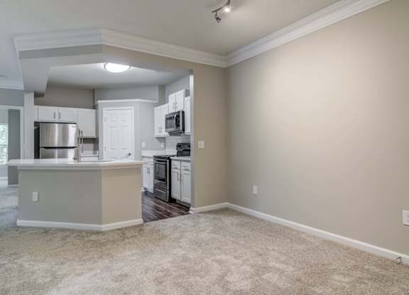 Apartments In Woodstock for Rent – Lea Woodstock – dining room area with plush carpeting with a v iew of the kitchen