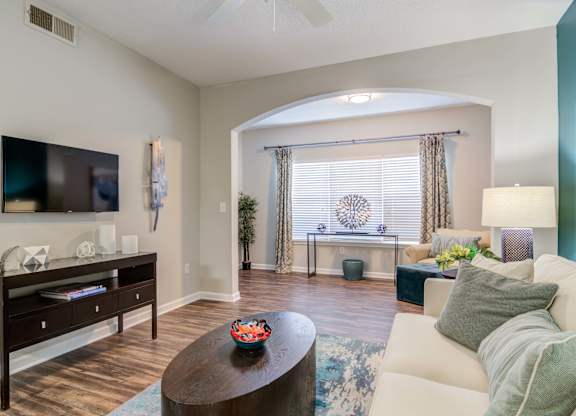 Pet-Friendly Apartments in Woodstock, GA – Lea Woodstock – living room with hard wood floors, ceiling fan and view of sunroom