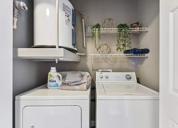 A small laundry room with a washer and dryer.