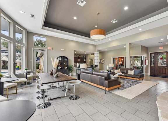 A spacious living room with a variety of seating options and a coffee table.