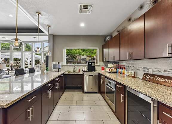 A kitchen with brown cabinets and a granite countertop.