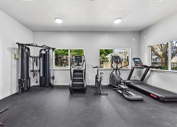 A spacious home gym with a variety of exercise equipment.