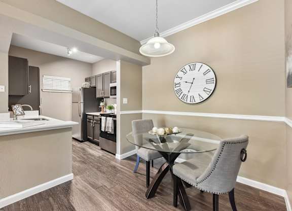 A dining room with a glass table and chairs.