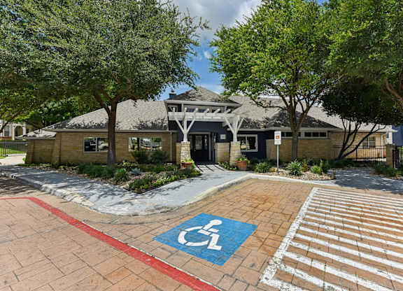 A building with a handicap parking spot in front.