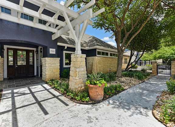 A house numbered 700 with a white pergola above the entrance.