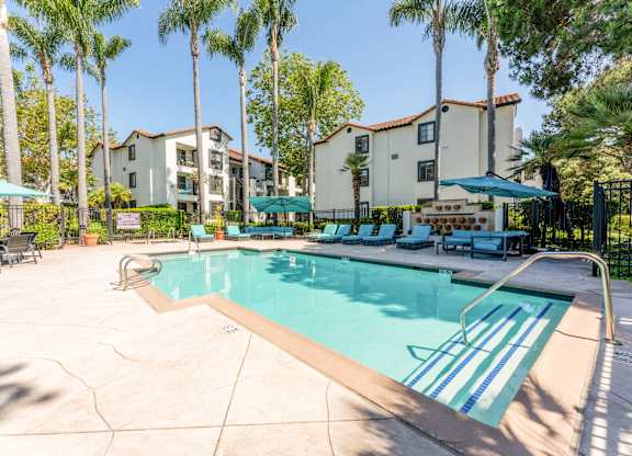 our apartments have a swimming pool with chairs and umbrellas