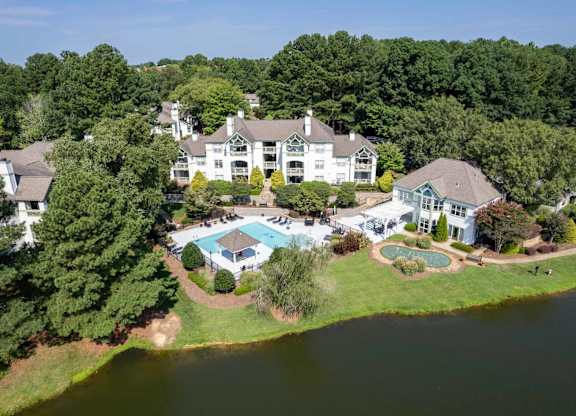 A large white house with a pool in the backyard.