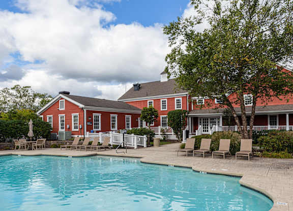 Orchards Apartments Marlborough ma apartment loft style apartments photo of  pool with lounge chairs and red siding clubhouse in background