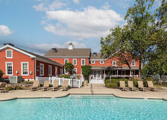 Orchards Apartments Marlborough ma apartment loft style apartments photo of  pool with lounge chairs and red siding clubhouse in background