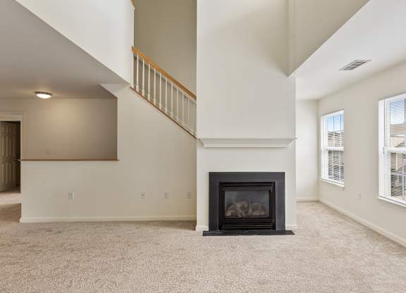 Orchards Apartments Marlborough ma apartment loft style apartments photo of living room with fireplace and stairs with carpet flooring and multiple windows