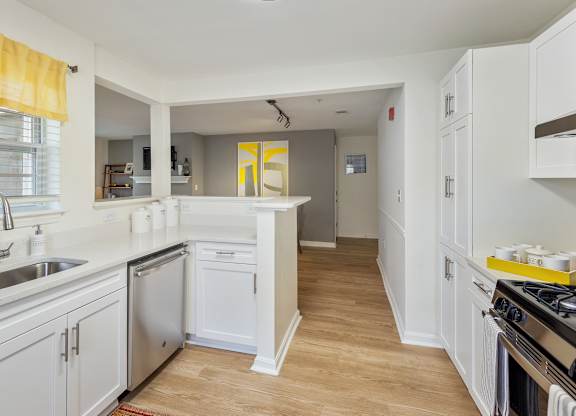 Orchards Apartments Marlborough ma apartment loft style apartments photo of kitchen stainless steel dishwasher and wood floors and white cabinets with dining room and living room with fireplace in background