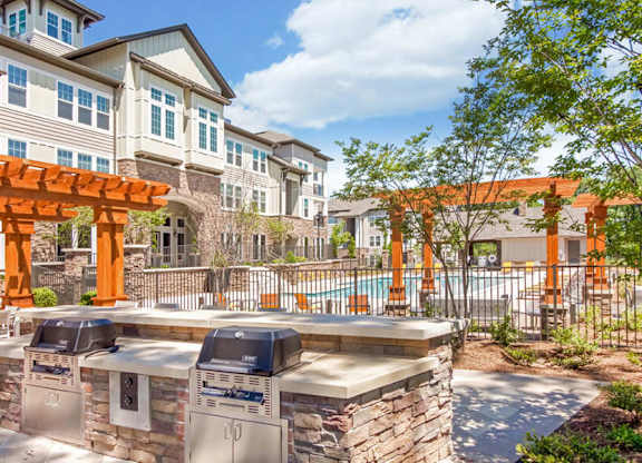 A sunny day at a residential area with a pool and a barbecue grill.