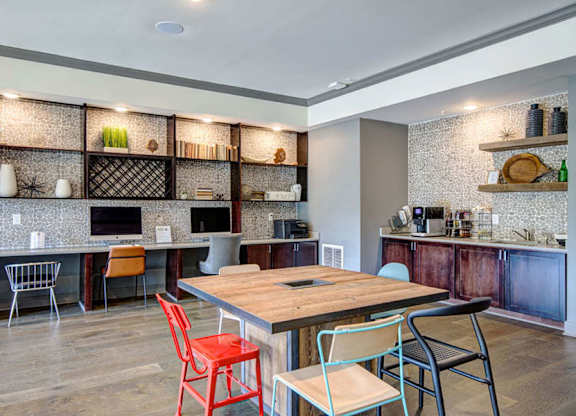 A kitchen with a wooden table and chairs.