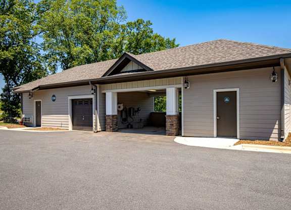 A small building with a garage door and a covered entrance.
