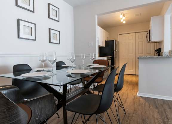 Pet-Friendly Apartments in Alpharetta, GA – Webb Bridge Crossing – dining room with a table and chairs and a kitchen in the background
