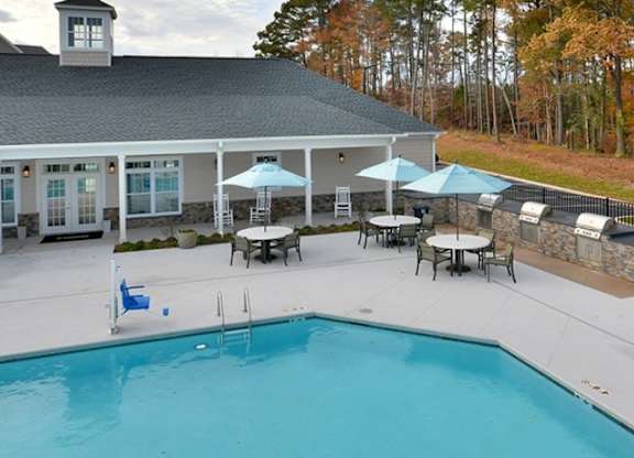 A pool with a building behind it.