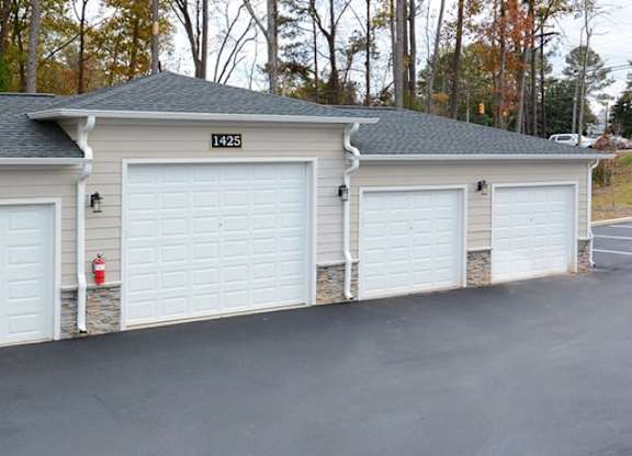 A three garage house with the number 123 on the top.