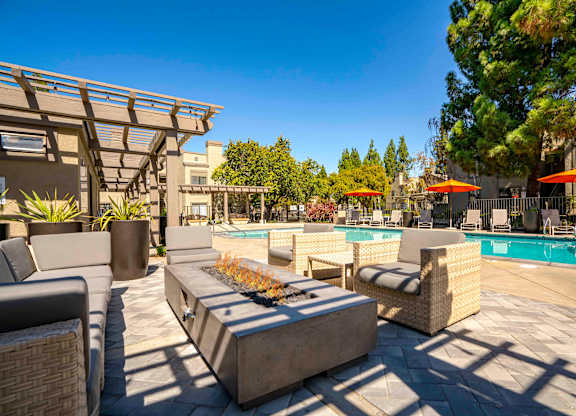 Apartments for Rent Walnut Creek, CA - Park Lake at Walnut Creek - Outdoor Lounge with Comfortable Seating, a Fire Table, by the Pool with Beautiful Landscaping