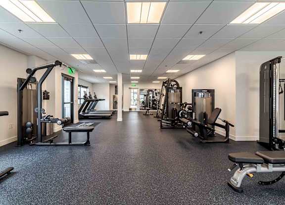 A spacious gym with various exercise equipment.