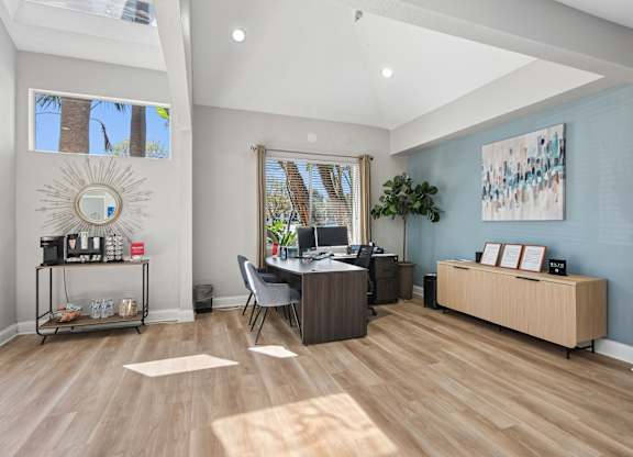 A room with a desk and a chair in it.