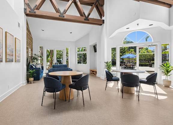 A dining room with a table and chairs.