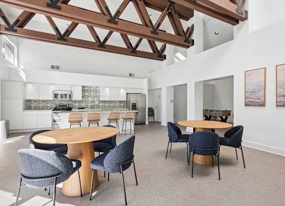 A room with a wooden table surrounded by chairs.