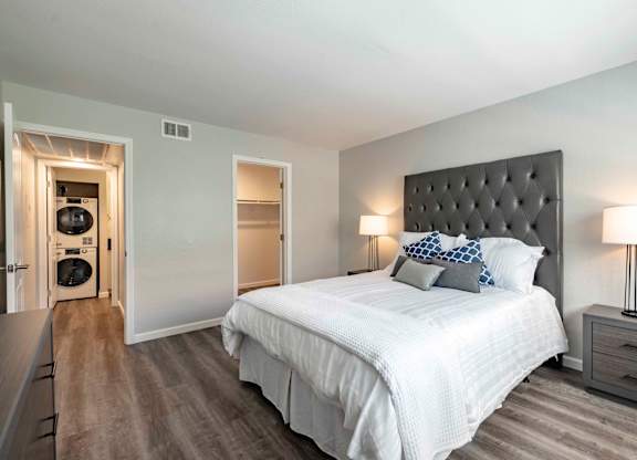 One Bedroom Apartments in San Clemente, CA - Rancho Del Mar - Bedroom with Bed, Oversized Closet, Attached Bathroom, and Nightstands with Lamps.