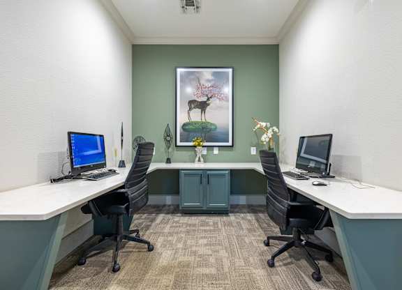 A room with two desks and two chairs.
