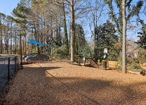 A gravel path leads through a wooded area.