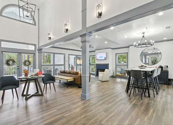 A modern living room with a dining area and a television.