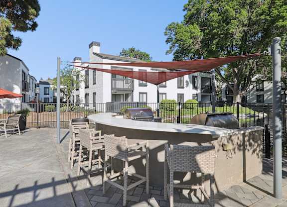 A patio with a table and chairs under a red awning.