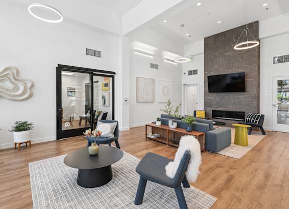 A modern living room with a black chair and a grey sofa.