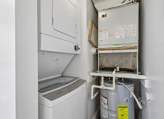A white washing machine and dryer in a small laundry room.