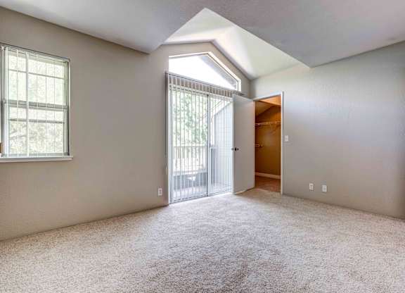 Apartments In San Jose, CA For Rent - Terra House - Spacious Bedroom With High Ceilings, Carpet Flooring, Large Closet, Window, And Access To Private Balcony