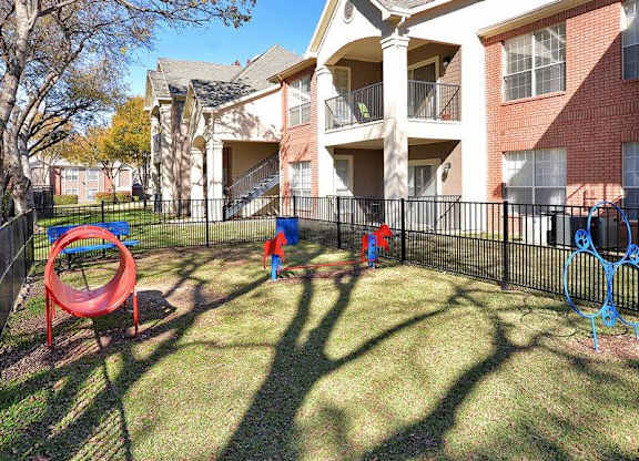 Plano Apartments for Rent - Carrington Park - Outside Pet Park with Jumping Hoops, Tunnel, and More Play Equipment