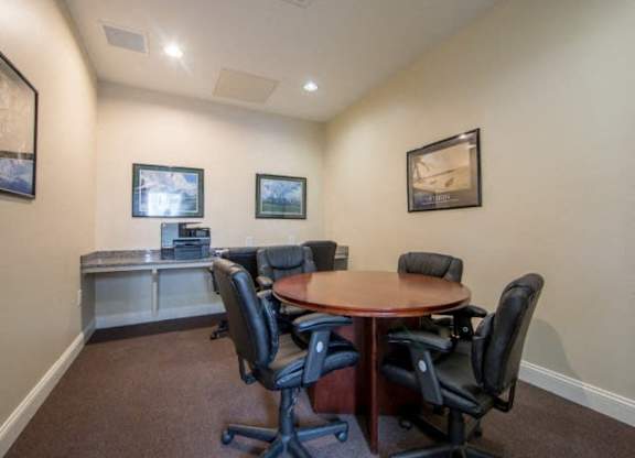 a conference room with a table and chairs