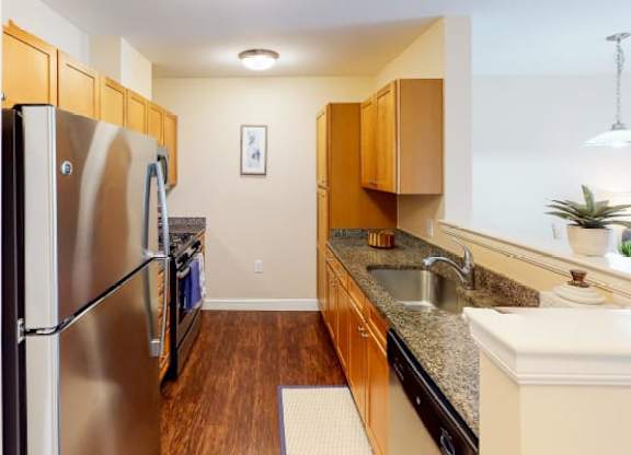 a kitchen with a stainless steel refrigerator freezer and a stove top oven