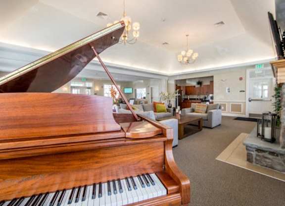 a piano sitting in a living room next to a fire place