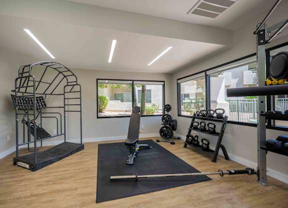 Affordable Apartments in Lakewood, AZ - Village at Lakewood - Fitness Center with a Bench Press, Dumbells, and Free Weights.