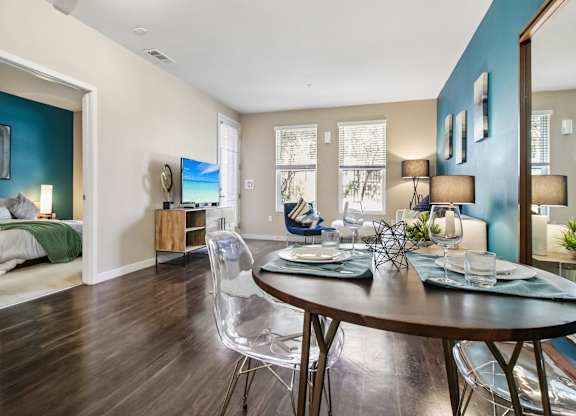 A dining room with a table set for two.