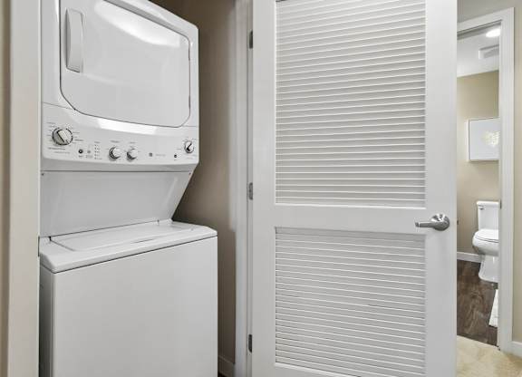 A white oven and toilet in a small bathroom.
