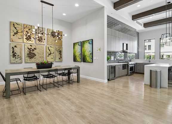 A modern dining room with a long table and chairs.