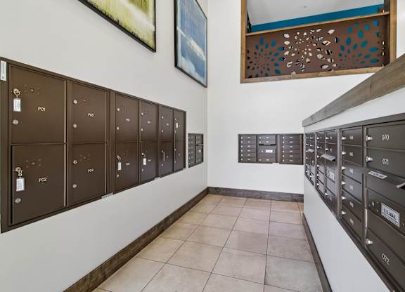 A row of mailboxes are lined up on a wall.