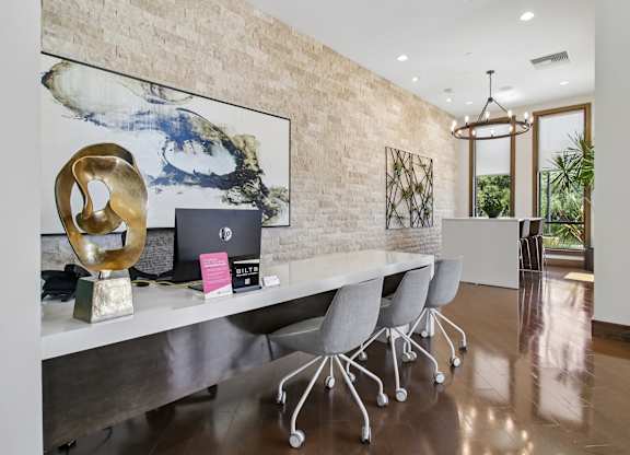 A modern office with a long table and chairs.
