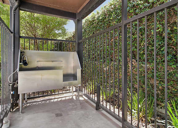 A metal gate with a screen door is closed.