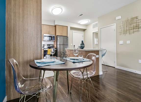 A dining room with a table set for two.