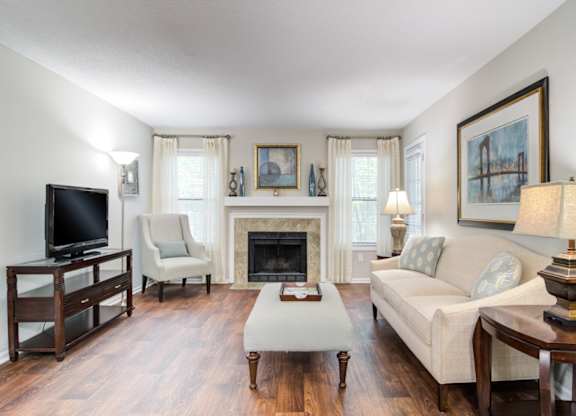Pet-Friendly Apartments in Marietta– Wood Pointe Apartments – A living room with a fireplace and a television.
